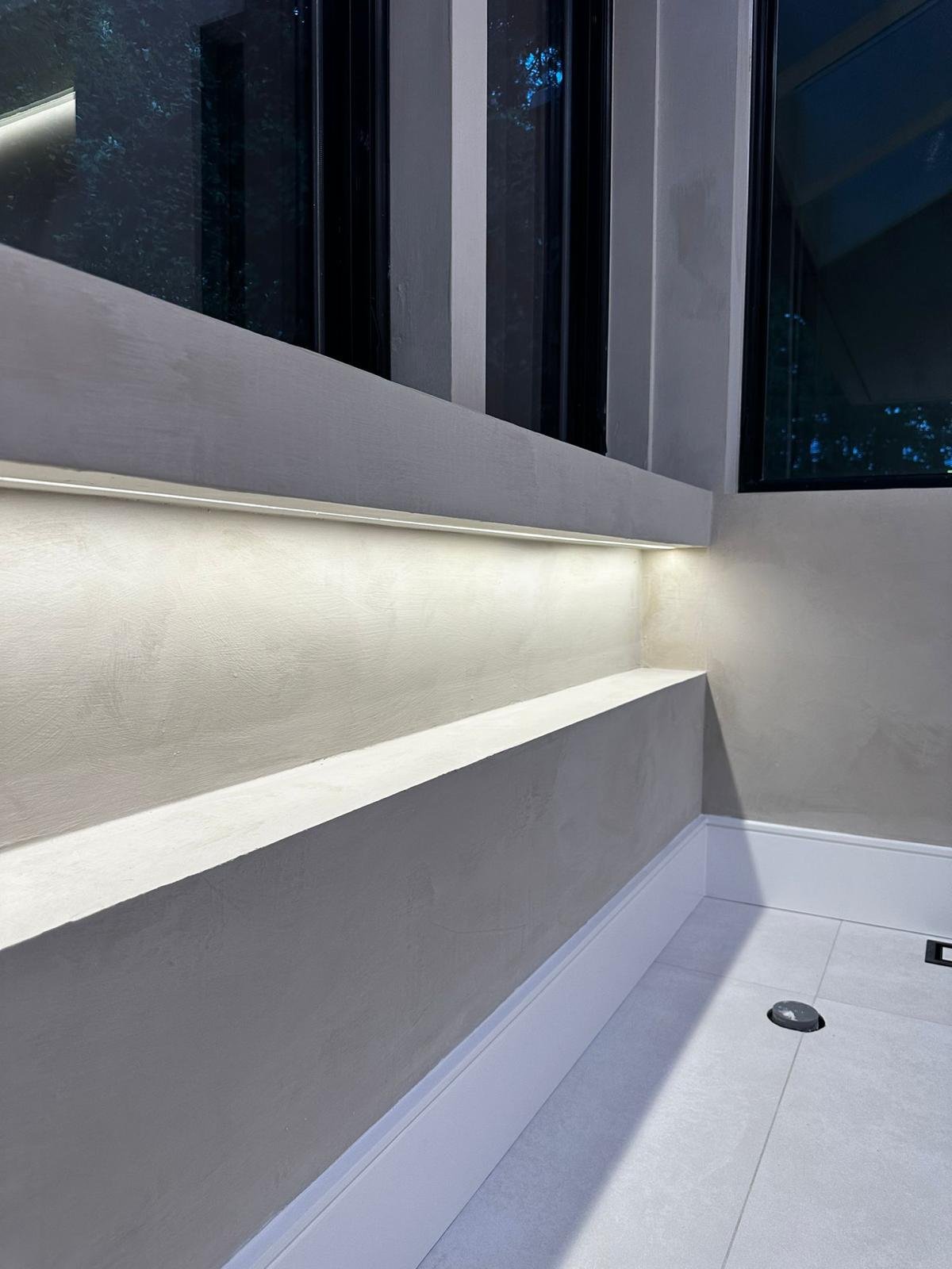 Greenpoint architectural microcement ledge in modern grey with LED cove and windows — MarkOn® Walls / Vlad Markov